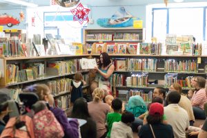 Drag Queen Story Time performer reads book at the Main Branch Children's Room
