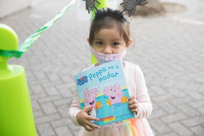 child holding peppa pig book