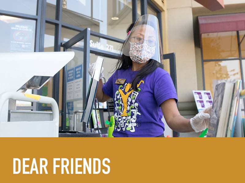 image of library staff in mask and face shield putting books on cart with gloves, text below reads 'dear friends'
